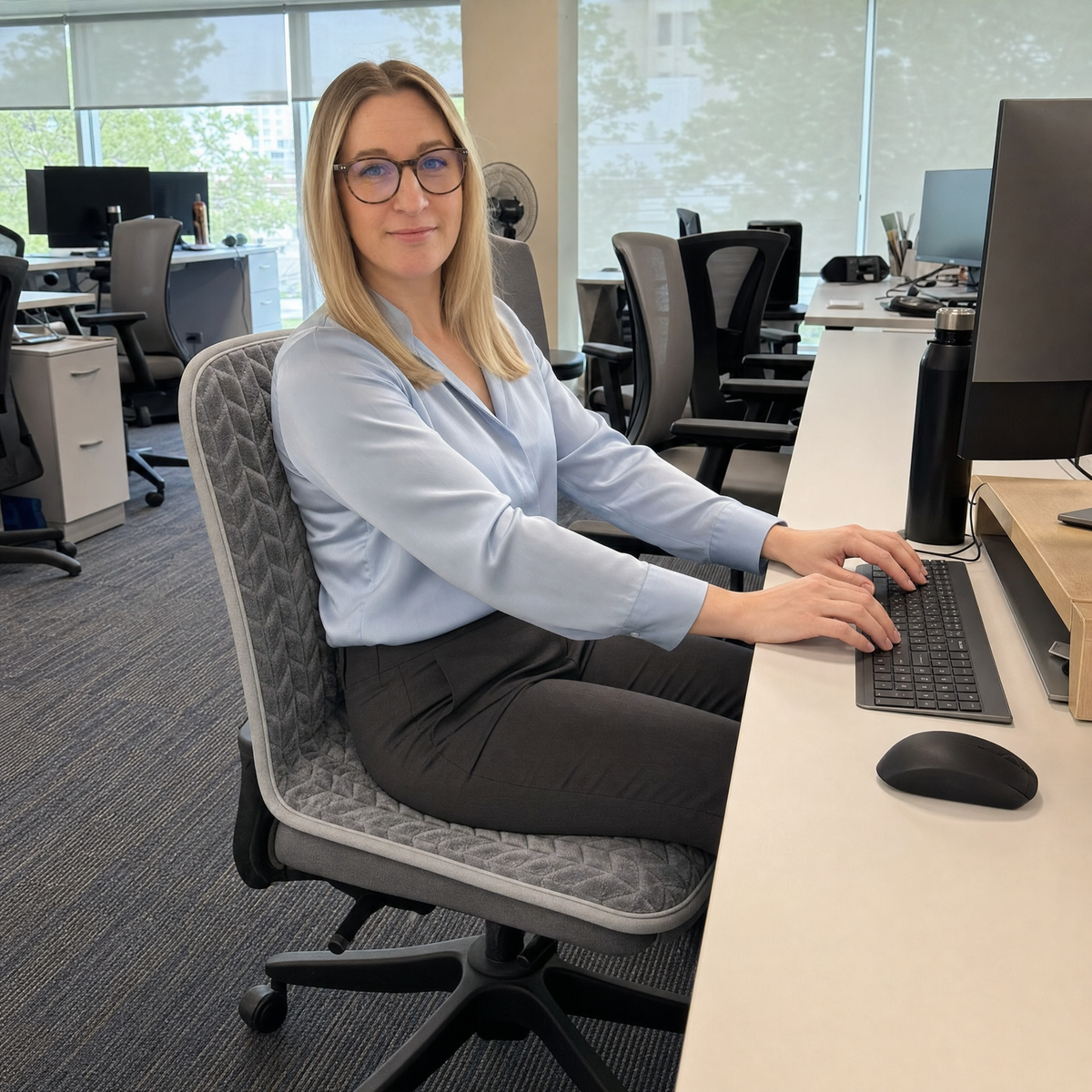 Woman working warm at her desk on Cozy Seat